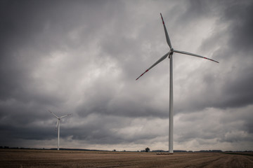 Windmill against cloudy sky