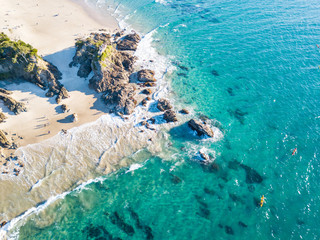 The Pass and Wategoes Beach at Byron Bay from an aerial view with blue water