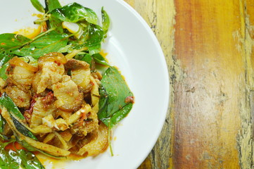 stir fried spicy wild boar and coconut shoot with red curry on plate