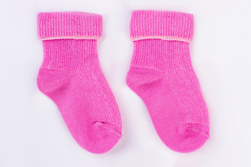 Homemade pink wool socks for baby.