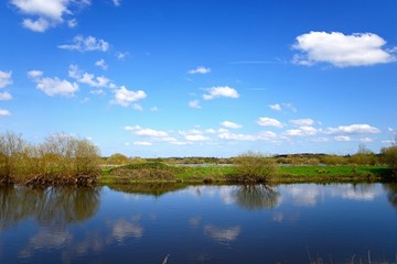 View across the River Tame towards marshland at the National Memorial Arboretum during the Springtime, Alrewas, UK.