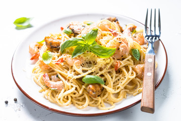 Pasta spaghetti with seafood and cream sauce on white.