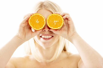Young woman with halves of oranges, close-up, isolated on white background
