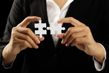 Businesswoman holding white puzzle isolated with clipping path.