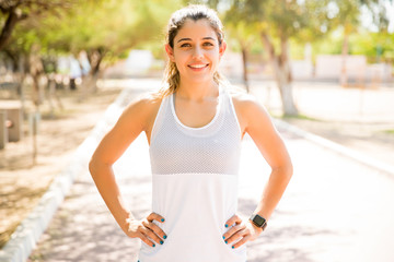 Confident female athlete at park
