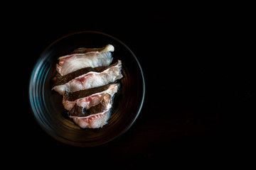 Meat kang catfish on black plate