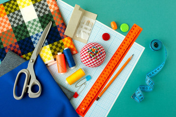 Fabric, graph paper and other items for sewing clothes. Millimeter paper, fabric, ruler, pencil,...