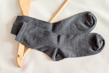 A pair of men's socks near the clothes hanger in the bedroom_
