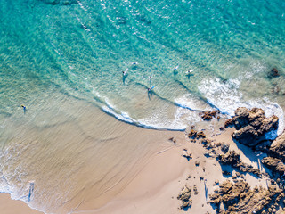 The Pass and Wategoes Beach at Byron Bay from an aerial view with blue water