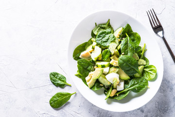 Green salad with avocado, spinach egg and cucumber. 