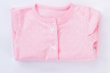 Pink folded baby pajamas isolated on white.