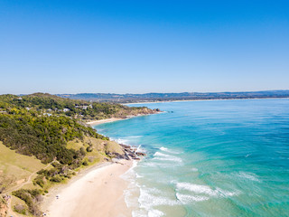 Fototapeta na wymiar The Pass and Wategoes Beach at Byron Bay from an aerial view with blue water
