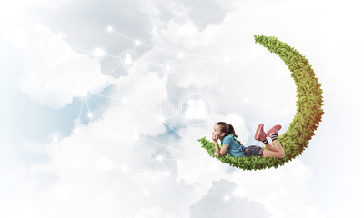 Concept of careless happy childhood with girl dreaming about som