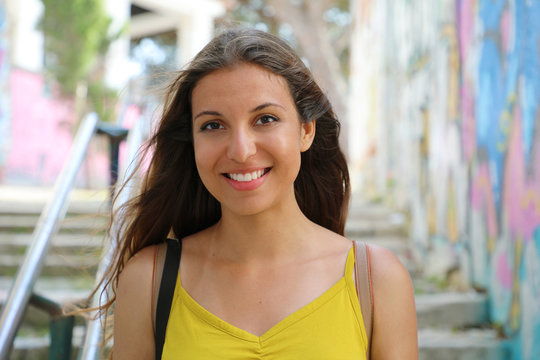 Portrait of young natural urban woman walking in Lisbon, Portugal