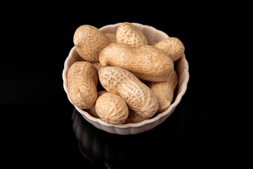 Fried peanut in shell on a black background