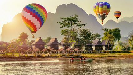 Hot air balloon over Nam Song river at sunset in Vang vieng, Laos. - obrazy, fototapety, plakaty