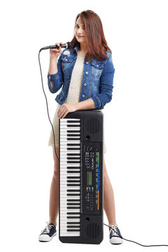 Young singer with microphone and synthesizer.