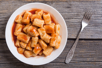 Homemade potatoes gnocchi with tomato sauce .
