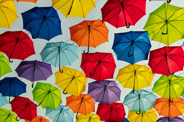 Multicolored umbrellas against the sky, street decorated
