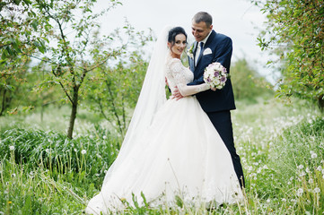 Fabulous wedding couple having their time outdoors in the garden on a special day.