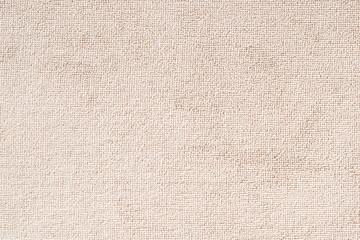 Carpet floor mat or beach towel texture background in beige color made of wool or synthetic fibers,...