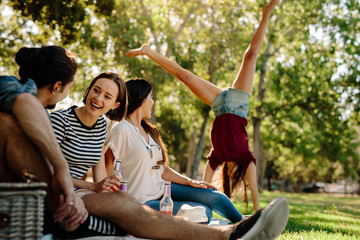 Young people enjoying picnic in park
