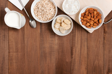 Wooden background with ingredients for healthy breakfast