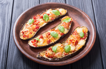 Eggplant with tomatoes , cheese and basil