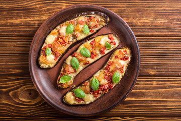 Eggplant with tomatoes , cheese and basil
