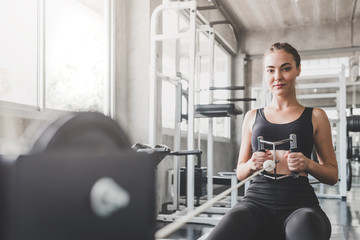 Young Caucasian woman exercising in gym. fitness concept