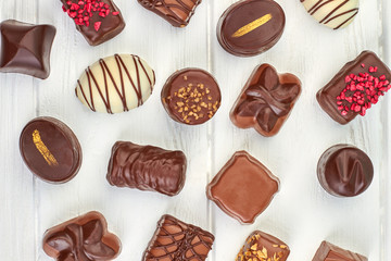 Confectionery sweet background. Variety of chocolate sweets on white background close up. Sweets...