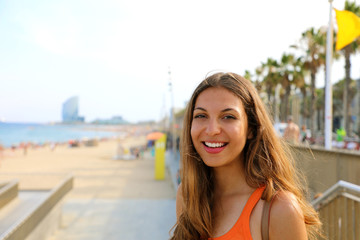 Smiling young woman going to Barceloneta, famous Barcelona beach, Catalonia, Spain - obrazy, fototapety, plakaty