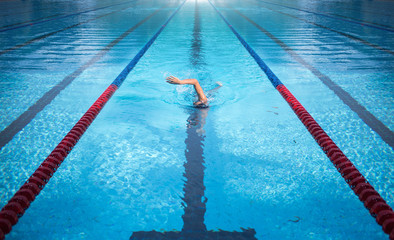 one man swimming on swimming pool lane