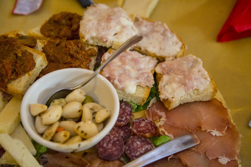 image with detail of typical Italian food products, salami and bruschetta.with wild boar sauce and lard