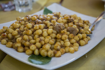 close-up with detail of a typical Italian dish called gnocchi with sausage sauce