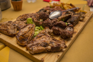 image of various types of grilled meat presented on a wooden chopping board