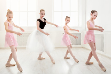 Teacher helping her students during dance class