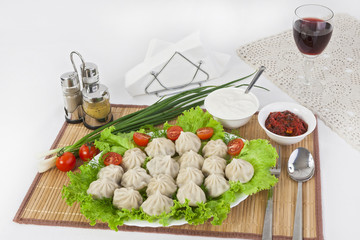 Kinkali in green with tomatoes and onions. Serve with soy sauce and sour cream.