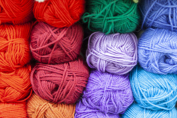 Store shelf with color yarn for knitting with needles, crochet hook.