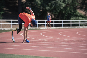 Disabled man athlete training with leg prosthesis