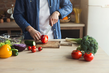 Man preparing delicious and healthy food in the home kitchen