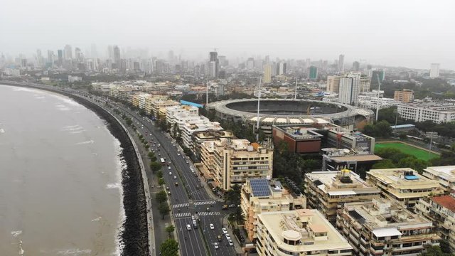 Aerial panoramic view of cityscape of Mumbai (Bombay) in monsoon season, business district skyscrapers skyline on horizon - modern capital city of Maharashtra, landscape panorama of India, Asia