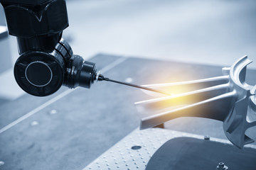 The multi-axis CMM machine measure the aluminum automotive part .The automotive part quality...