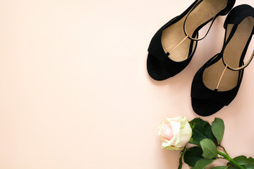 Stylish classic black women's leather sandals shoes with high heels on pink purple multi-colored paper background. Copy space, Top view.  Flat lay. Celebration or shoe sell concept.