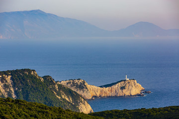 Fototapeta na wymiar Sunset view with magical lighthouse over Cape of Doukato, Lefkada island in Ionian Sea, Lefkas, Greece