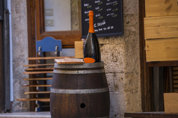 image of a wine barrel with a bottle and a wooden cutting board
