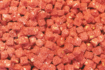 turkish delight with pistachios in glitter pink and pomegranate on wooding