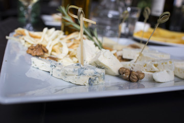 Parmesan cheese, Camembert, Gorgonzola, brie on a white plate in a cafe