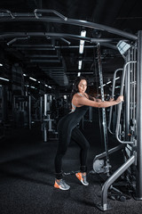 Young beautiful athlete woman in the gym