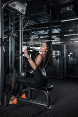 Fototapeta na wymiar Young beautiful athlete woman in the gym